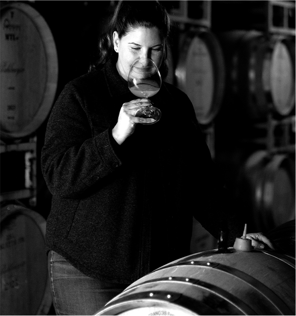 Katie Vogt, legendary winemaker, taking in the aroma of a glass of wine.