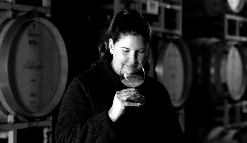 Katie Vogt, legendary winemaker, taking in the aroma of a glass of wine.